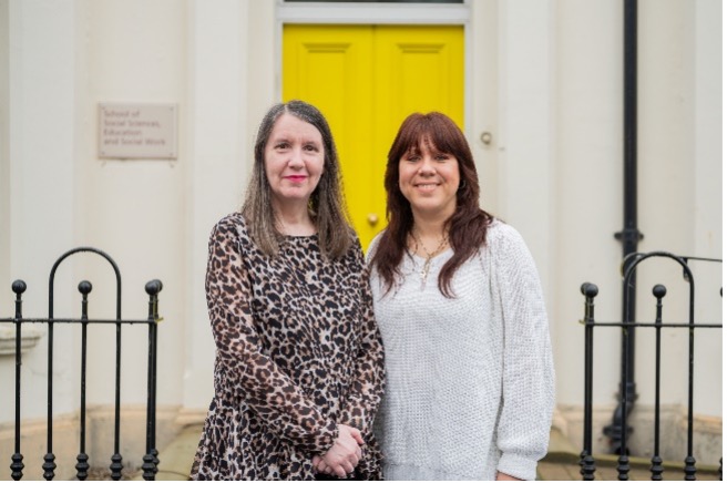 QUB School of Social Sciences, Education and Social Work Host Co-Worker Margaret Mullany, Daniela Tatarkova Inclusive Employment Scheme Placement standing in front of a yellow door